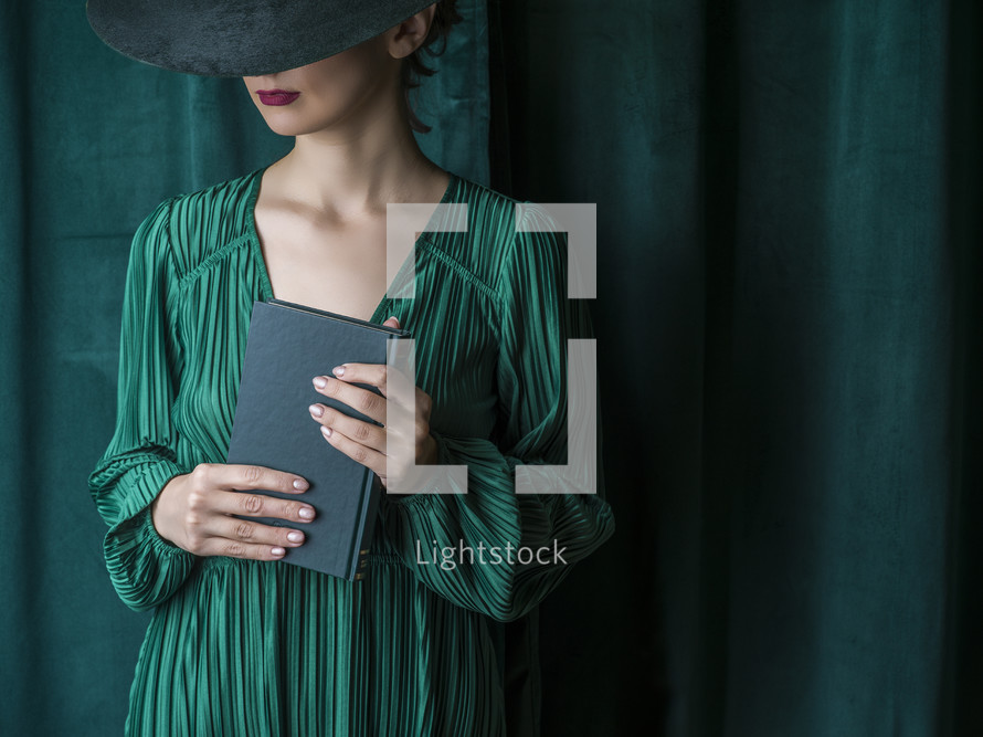 woman in green holding a Bible 