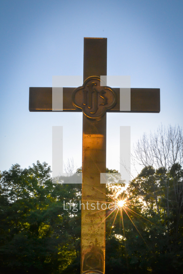 sunburst behind a cross (vertical)