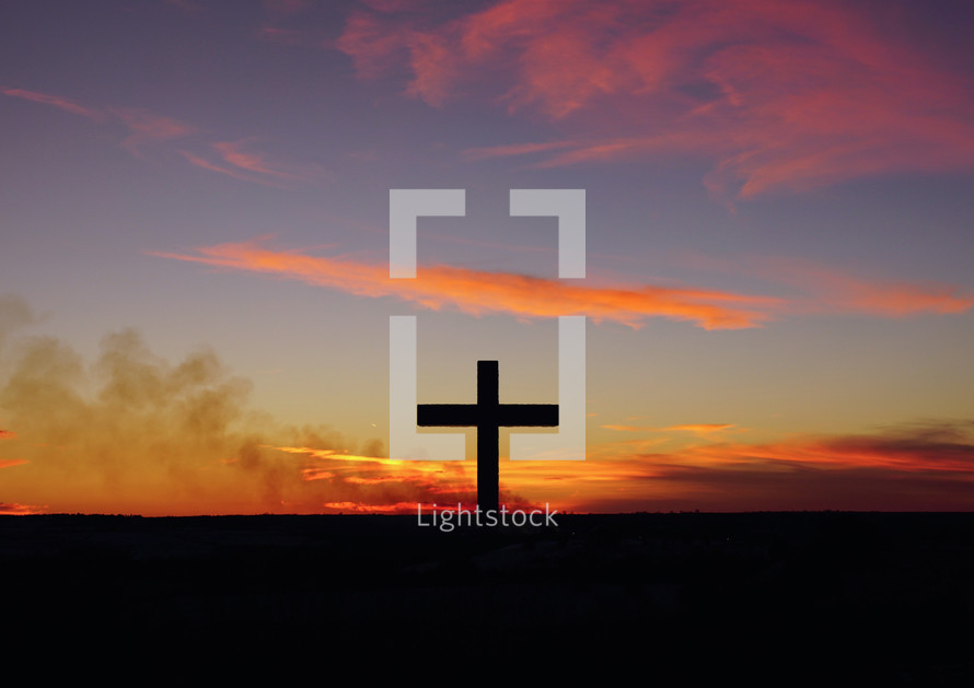 silhouette of a cross at sunrise 