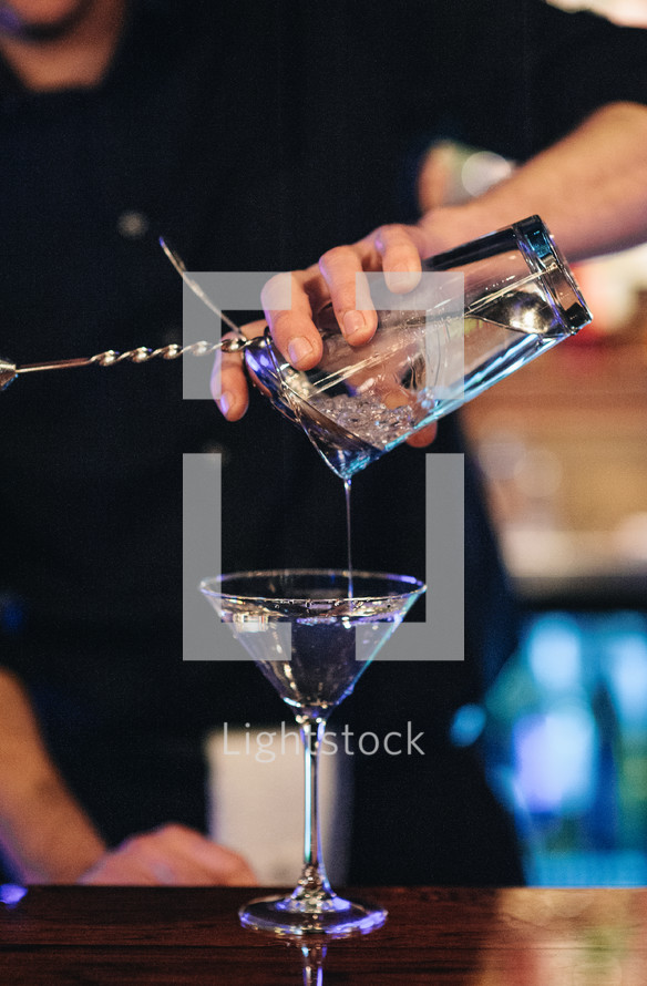 bartender pouring a cocktail 