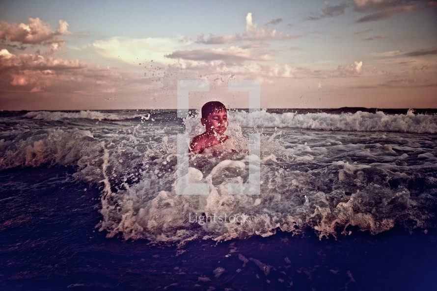 child playing in the ocean