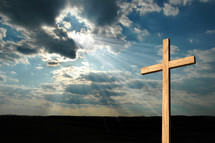rays of sunlight shining on a cross