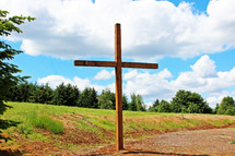 A large wooden cross in the countryside.