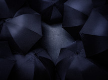 Black umbrellas on black background