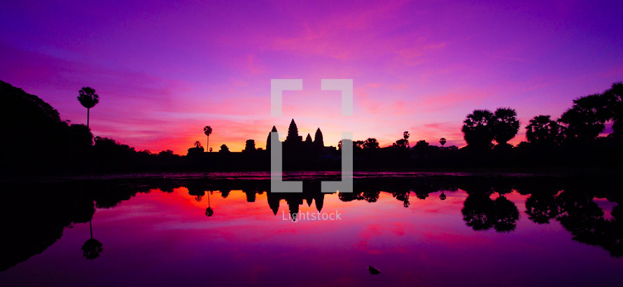 Sunrise over Angkor Wat reflected in water. 
