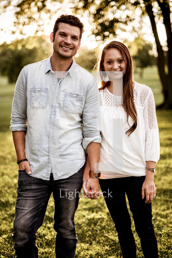 young couple standing together outdoors 