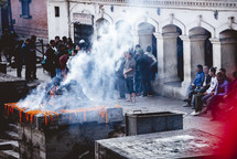 people gathered around a ceremonial fire in Tibet