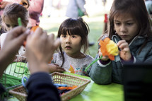 Little girls creating flowers at a fall festival