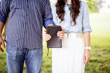 couple holding a Bible together 