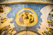 biblical paintings on a ceiling of an ancient church 