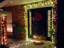 Christmas lights and wreath in entryway of home