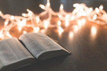 white Christmas lights and open Bible 