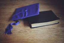 a mortar board and Bible together to celebration this young grad's new chapter
