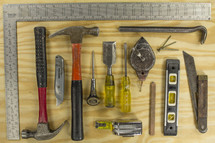 A flat lay of common carpentry tools