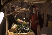 vendor at the market in Biblical times selling to a rich man