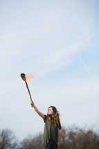 a woman holding up a burning torch 