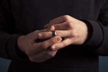 a man taking off his wedding ring 