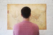 a man looking at a world map 