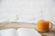 open Bible and coffee mug