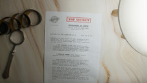 Sheet, placed on a desk, containing confidential information