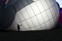 a man standing near a hotter balloon 