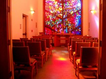 sunlight through a stained glass window in a chapel 