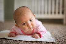 newborn on a nursery floor 