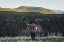 man with guitar in the mountains