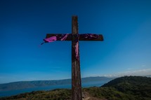 purple shroud on a wooden cross 