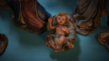 CGI Colorful Christmas Nativity set on coffee table focusing on Baby Jesus.