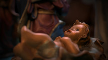 CGI Colorful Christmas Nativity set on coffee table focusing on Baby Jesus.