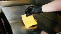 Covering The Cooking Meat With Cheddar