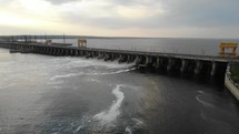 Powerful stream of water falls from the shutter in the dam, hydroelectric