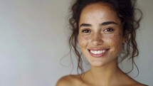 Joyful woman with freckles, natural beauty, genuine smile.