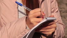 woman taking notes 