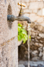 water pouring out of a spigot 