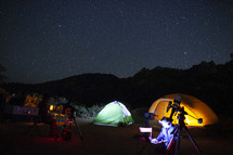 Astronomers camping under the stars with telescopes