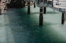 green ocean water under pier