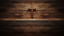 Wooden cross on a wood background with copy space.