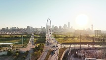 Aerial video of the Margaret Hunt Hill Bridge in downtown Dallas, Texas on a beautiful clear blue sky morning