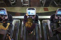 women walking on treadmills at the gym