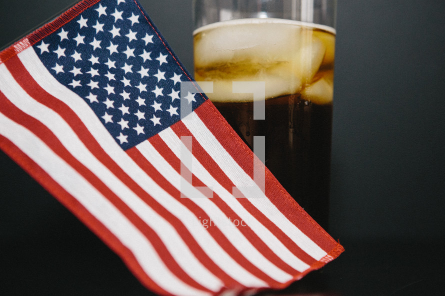 hand held American flag and a glass of coke