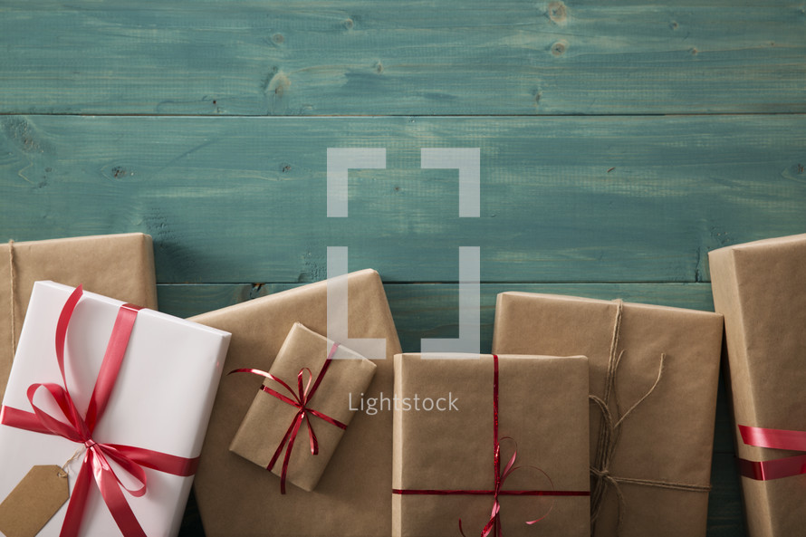 border of wrapped gifts on a wood floor