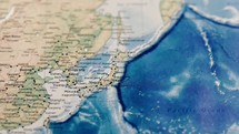 Asian coast on atlas map