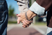 an elderly couple holding hands 