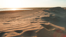 Fine sand dunes next to sea water