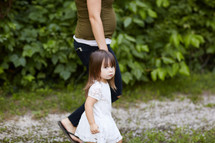 a little girl walking holding mom's hand 