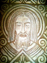 A mosaic image of Jesus Christ engraved in stone. 