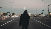 a man standing in the middle of a highway 