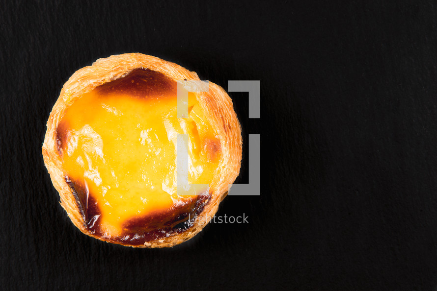 Top view Egg Tarts or pasteis de nata  on black background. Typical portuguese sweet